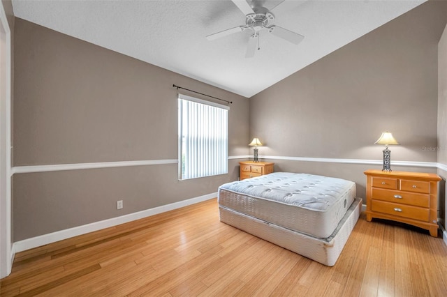 13777 Forest Lake Dr, Largo, FL 33771 - bedroom featuring baseboards, lofted ceiling, ceiling fan, and light wood-style flooring