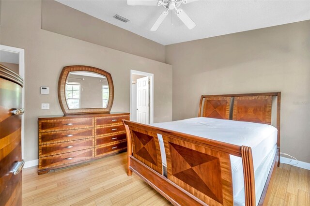 13777 Forest Lake Dr, Largo, FL 33771 - bedroom featuring light wood-type flooring, visible vents, a ceiling fan, and baseboards