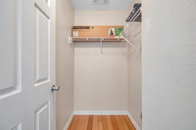 13777 Forest Lake Dr, Largo, FL 33771 - walk in closet featuring wood finished floors