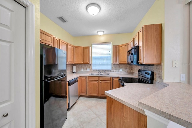 13777 Forest Lake Dr, Largo, FL 33771 - kitchen with decorative backsplash, visible vents, a sink, and black appliances
