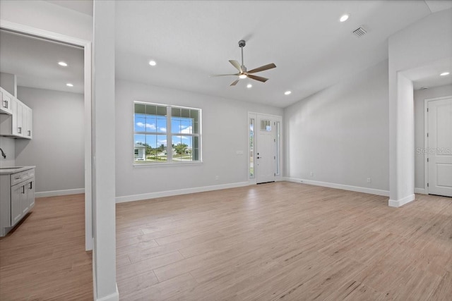 10493 Grail Ave, Englewood, FL 34224 - unfurnished living room with light wood-type flooring, a ceiling fan, visible vents, recessed lighting, and baseboards