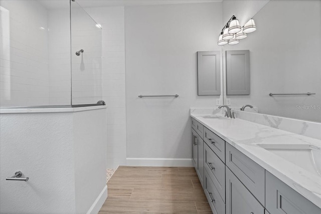 10493 Grail Ave, Englewood, FL 34224 - full bath featuring a sink, baseboards, a walk in shower, and double vanity