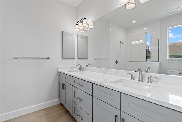 10493 Grail Ave, Englewood, FL 34224 - full bath with tiled shower, double vanity, a sink, and visible vents