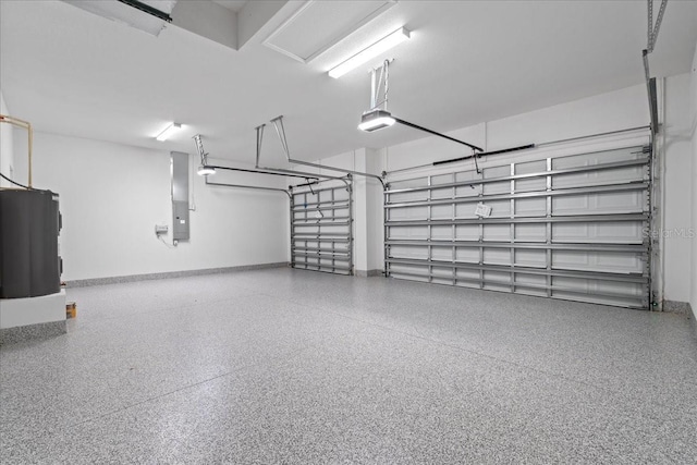 10493 Grail Ave, Englewood, FL 34224 - garage with electric panel, water heater, baseboards, and a garage door opener