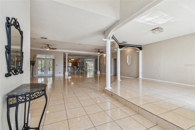284 Peninsula Ave, Tarpon Springs, FL 34689 - foyer entrance featuring ornate columns, ceiling fan, light tile patterned floors, french doors, and baseboards