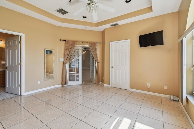 284 Peninsula Ave, Tarpon Springs, FL 34689 - empty room with a raised ceiling and light tile patterned flooring
