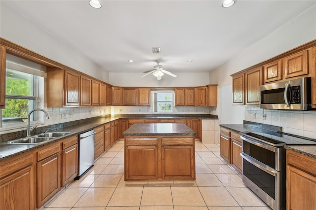 284 Peninsula Ave, Tarpon Springs, FL 34689 - kitchen with stainless steel appliances, a sink, backsplash, brown cabinetry, and recessed lighting