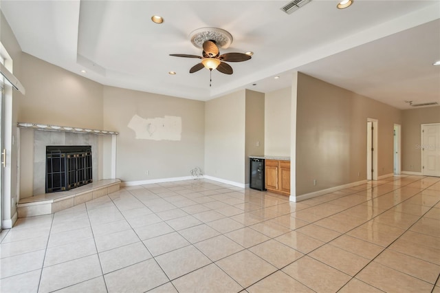 284 Peninsula Ave, Tarpon Springs, FL 34689 - unfurnished living room featuring recessed lighting, a tiled fireplace, beverage cooler, a ceiling fan, and light tile patterned flooring