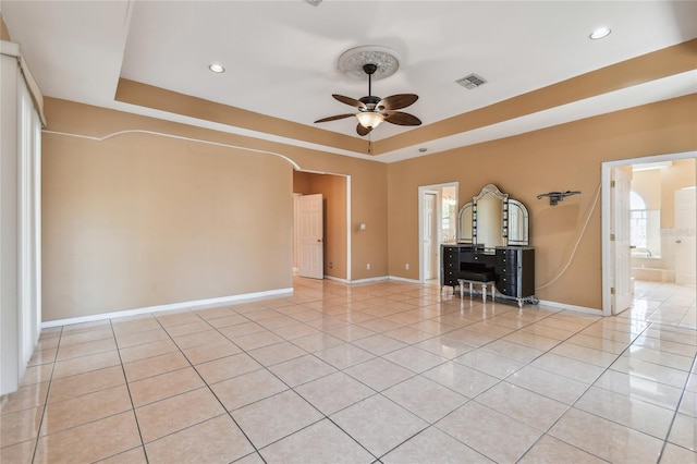 284 Peninsula Ave, Tarpon Springs, FL 34689 - empty room with ceiling fan, a tray ceiling, baseboards, light tile patterned floors, and recessed lighting