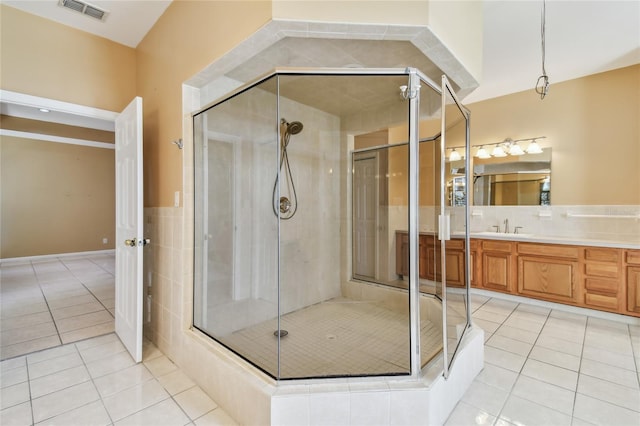284 Peninsula Ave, Tarpon Springs, FL 34689 - full bathroom featuring tile patterned floors, a shower stall, and vanity