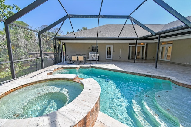 284 Peninsula Ave, Tarpon Springs, FL 34689 - view of swimming pool with a pool with connected hot tub, a patio, area for grilling, and glass enclosure