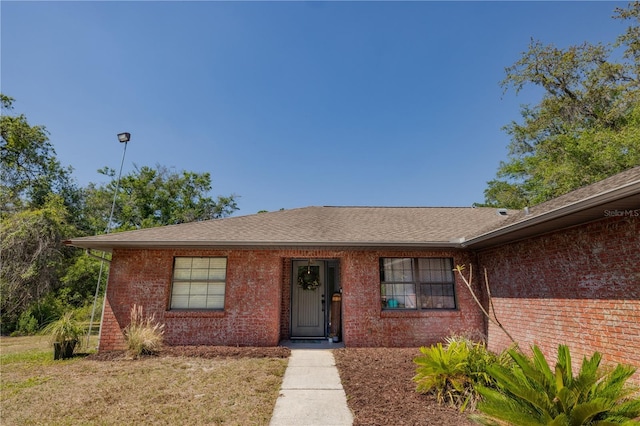35109 Excalibur, Webster, FL 33597 - view of front of home featuring roof with shingles and brick siding