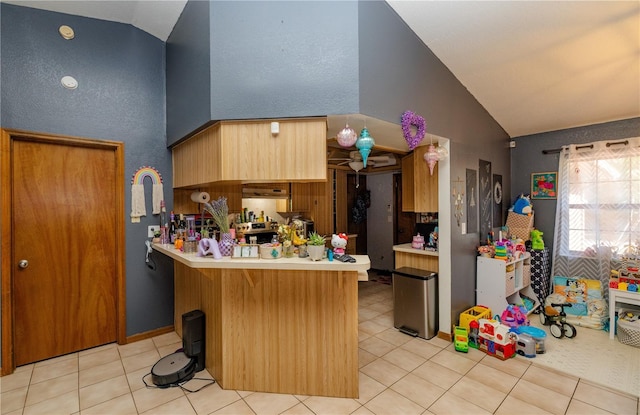 35109 Excalibur, Webster, FL 33597 - kitchen with light tile patterned flooring, a peninsula, high vaulted ceiling, and light countertops