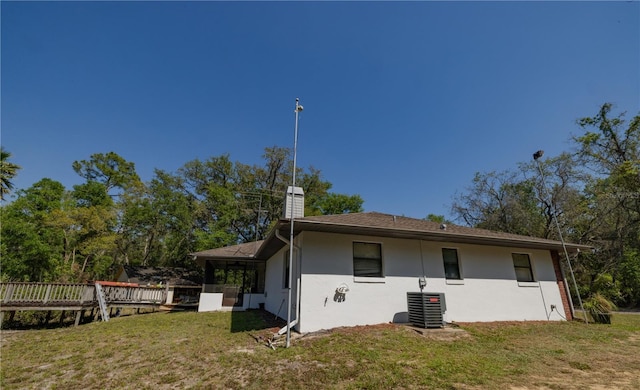 35109 Excalibur, Webster, FL 33597 - rear view of property featuring a yard, a sunroom, stucco siding, and a chimney