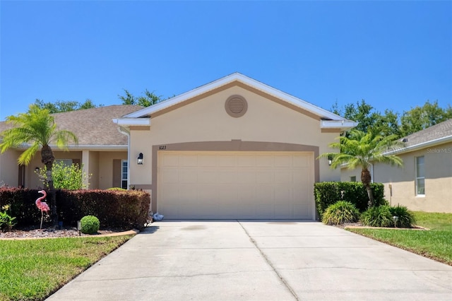 1023 Orca Ct, Holiday, FL 34691 - ranch-style house featuring stucco siding, driveway, and a garage
