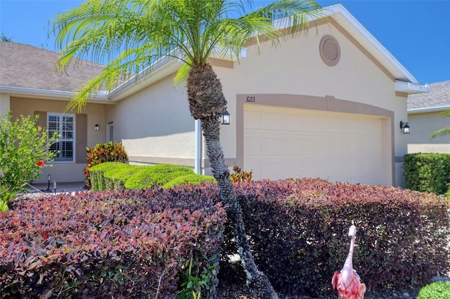 1023 Orca Ct, Holiday, FL 34691 - view of home's exterior with a garage and stucco siding