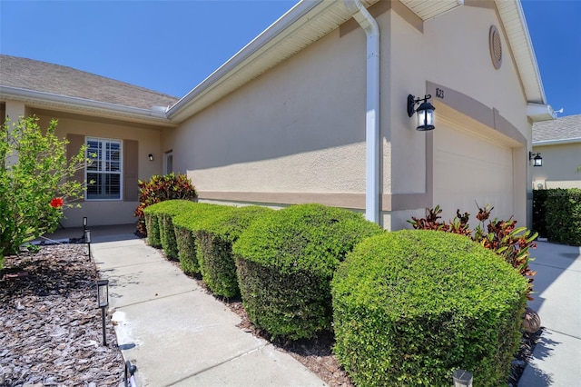 1023 Orca Ct, Holiday, FL 34691 - view of side of home featuring stucco siding