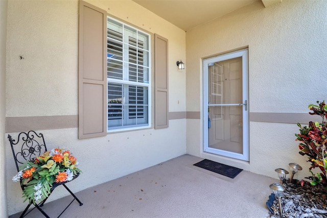1023 Orca Ct, Holiday, FL 34691 - doorway to property featuring stucco siding