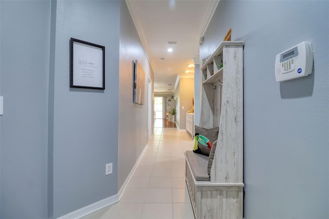 1023 Orca Ct, Holiday, FL 34691 - hall with visible vents, crown molding, baseboards, and light tile patterned floors