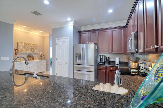 1023 Orca Ct, Holiday, FL 34691 - kitchen featuring dark stone countertops, dark brown cabinets, visible vents, a sink, and appliances with stainless steel finishes