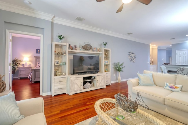 1023 Orca Ct, Holiday, FL 34691 - living room with ornamental molding, a ceiling fan, dark wood-style floors, and visible vents