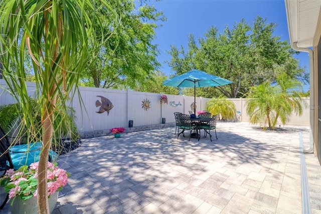 1023 Orca Ct, Holiday, FL 34691 - view of patio with a fenced backyard and outdoor dining space