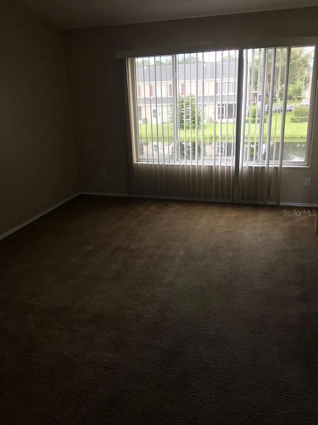 244 Countryside Key Blvd, Oldsmar, FL 34677 - spare room featuring dark carpet and baseboards