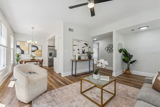 307 S Newport Ave, Tampa, FL 33606 - living area featuring wood finished floors, ceiling fan with notable chandelier, baseboards, and visible vents