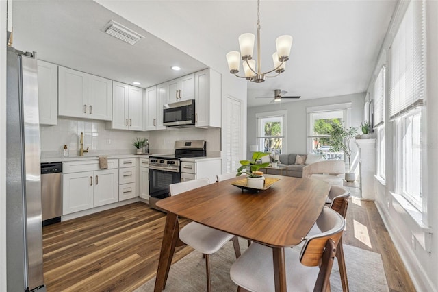 307 S Newport Ave, Tampa, FL 33606 - dining area featuring dark wood-type flooring, visible vents, recessed lighting, and ceiling fan with notable chandelier