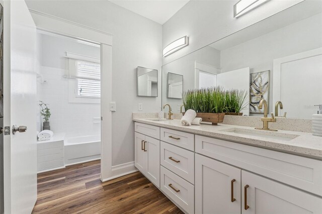 307 S Newport Ave, Tampa, FL 33606 - full bathroom featuring wood finished floors, double vanity, a sink, and baseboards