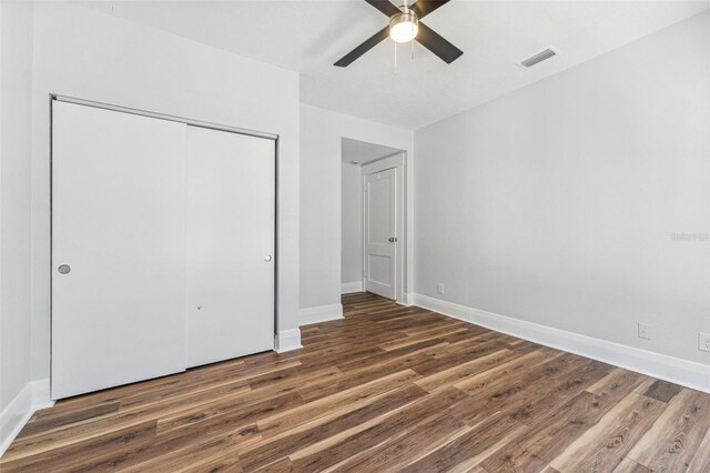 307 S Newport Ave, Tampa, FL 33606 - unfurnished bedroom featuring visible vents, baseboards, a closet, and wood finished floors