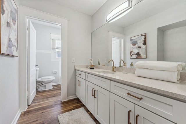 307 S Newport Ave, Tampa, FL 33606 - bathroom featuring toilet, vanity, wood finished floors, and baseboards