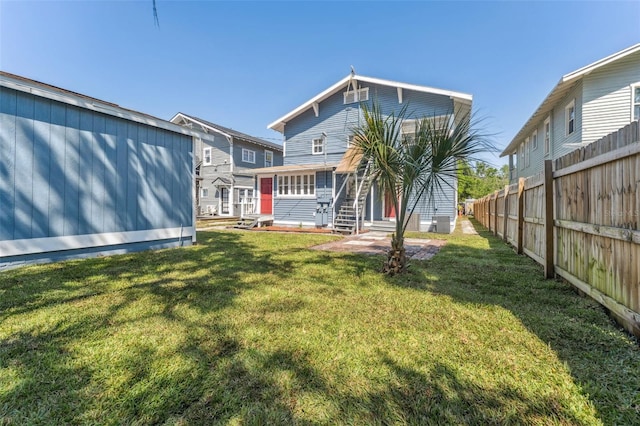 307 S Newport Ave, Tampa, FL 33606 - back of house featuring a yard, entry steps, and fence