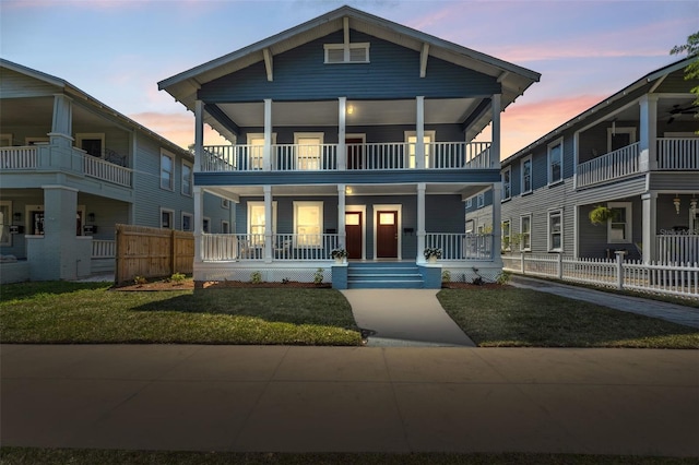 307 S Newport Ave, Tampa, FL 33606 - view of front of property featuring a porch, a front yard, fence, and a balcony