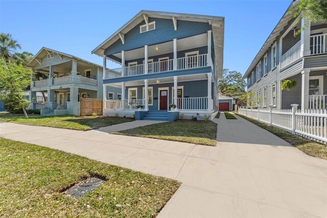 307 S Newport Ave, Tampa, FL 33606 - view of front of home featuring a detached garage, a porch, fence, a front lawn, and a balcony