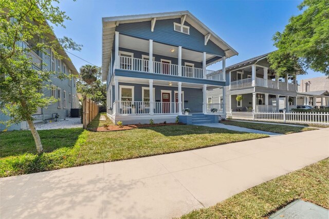 307 S Newport Ave, Tampa, FL 33606 - view of front of property with a front lawn, fence, covered porch, and a balcony