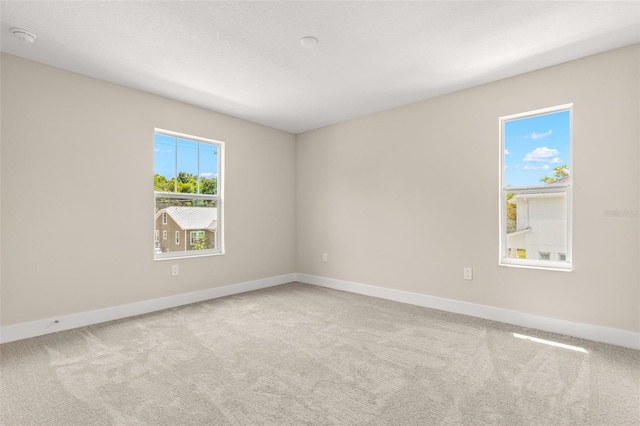 carpeted spare room with baseboards