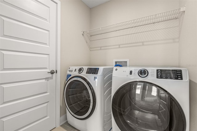 clothes washing area with separate washer and dryer and laundry area