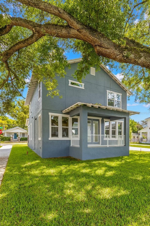 view of home's exterior with stucco siding and a yard