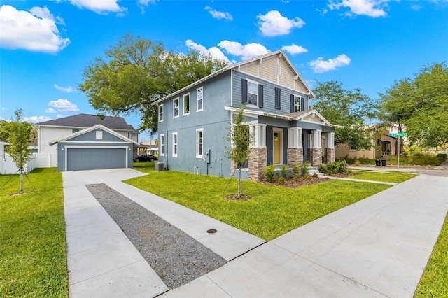 view of front of house featuring fence, stone siding, a front yard, stucco siding, and driveway
