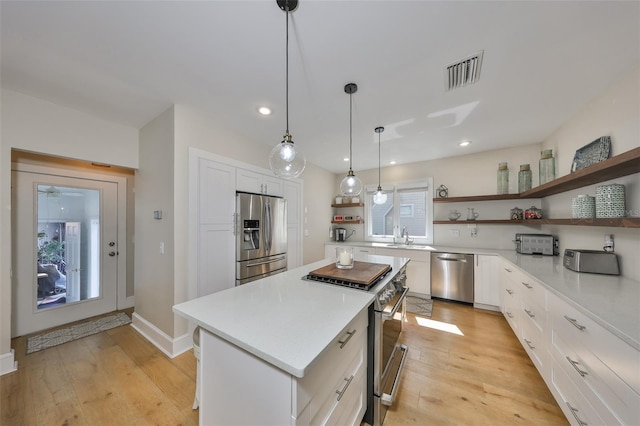 2802 Old Bayshore Way, Tampa, FL 33611 - kitchen featuring open shelves, appliances with stainless steel finishes, light countertops, white cabinets, and recessed lighting