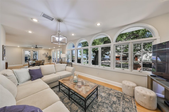2802 Old Bayshore Way, Tampa, FL 33611 - living room featuring recessed lighting, baseboards, plenty of natural light, and wood finished floors