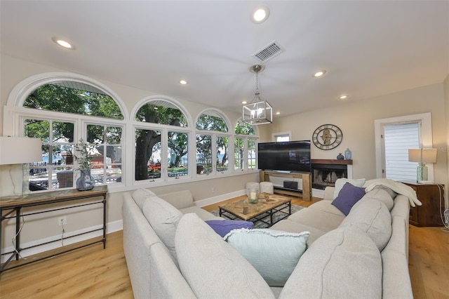 2802 Old Bayshore Way, Tampa, FL 33611 - living area featuring wood finished floors, recessed lighting, a chandelier, and baseboards