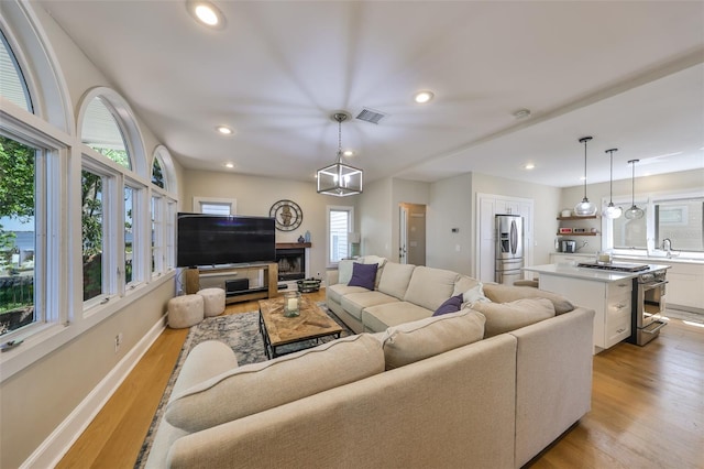 2802 Old Bayshore Way, Tampa, FL 33611 - living room with light wood-style floors, recessed lighting, baseboards, and a fireplace