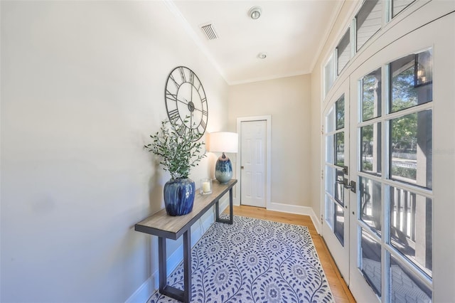 2802 Old Bayshore Way, Tampa, FL 33611 - doorway with light wood-type flooring, baseboards, crown molding, and french doors