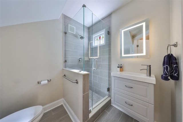 2802 Old Bayshore Way, Tampa, FL 33611 - bathroom with toilet, vanity, a stall shower, baseboards, and wood finished floors