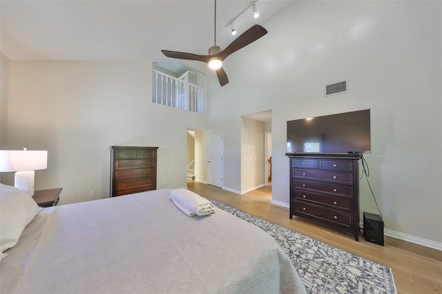 2802 Old Bayshore Way, Tampa, FL 33611 - bedroom with wood finished floors, baseboards, a towering ceiling, and ceiling fan