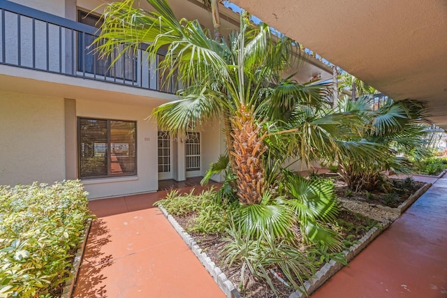 6357 Bahia Del Mar Blvd Unit 111, Saint Petersburg, FL 33715 - view of exterior entry featuring stucco siding and a balcony