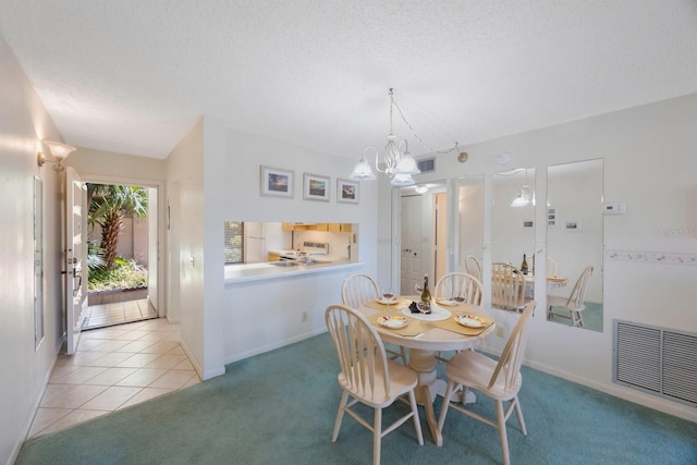 6357 Bahia Del Mar Blvd Unit 111, Saint Petersburg, FL 33715 - dining space featuring an inviting chandelier, a textured ceiling, visible vents, and light carpet