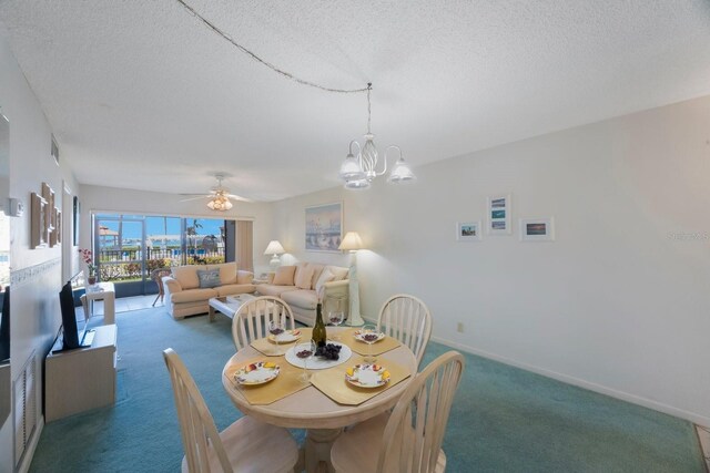 6357 Bahia Del Mar Blvd Unit 111, Saint Petersburg, FL 33715 - carpeted dining room featuring baseboards, a textured ceiling, and ceiling fan with notable chandelier